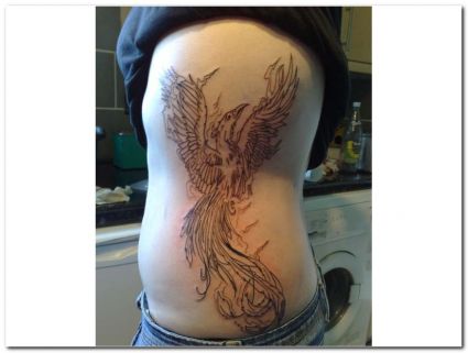 Tribal Phoenix Image Tattoo On Rib 